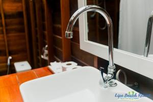 a sink with a faucet in a bathroom at Lipe Beach Resort in Ko Lipe
