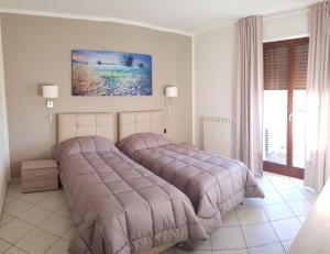 a bedroom with two beds and a window at Case Così Apartments - Verona in Verona