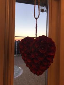 a heart shaped bouquet of red roses hanging from a window at Artemide Relais in Montebelluna