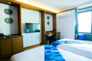 Postel nebo postele na pokoji v ubytování Lavana Hotel Chiangmai