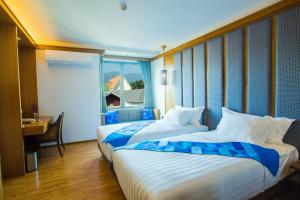 Postel nebo postele na pokoji v ubytování Lavana Hotel Chiangmai