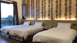 Postel nebo postele na pokoji v ubytování Taroko Inn