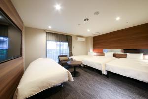 Postel nebo postele na pokoji v ubytování The Hedistar Hotel Narita