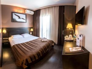 a hotel room with a large bed and a window at Bartolomeo in Dnipro