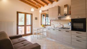 a living room with a couch and a kitchen at Appartamenti La Casina in Porto Azzurro