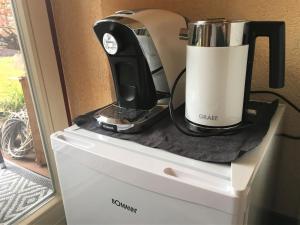 a black and white appliance sitting on top of a dresser at Gästezimmer Hortensie in Weil der Stadt