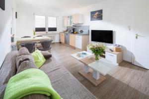 ein Wohnzimmer mit einer Couch und einem Tisch in der Unterkunft Ferienhaus an der Karlstraße in Norderney