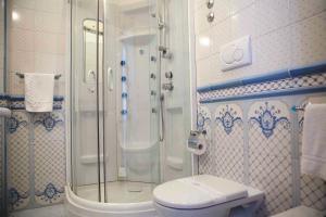 a bathroom with a shower and a toilet at Hotel Voce del Mare in Vietri