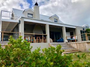 a house on the beach with chairs at Seabreeze in Kommetjie