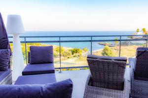 a balcony with chairs and a view of the ocean at BS Luxury Estate El Campello in El Campello