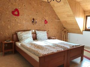 a bedroom with a large bed in a room at Les Berges de l'Ohmbach in Soultzmatt