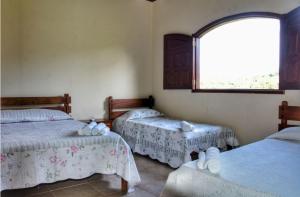 Säng eller sängar i ett rum på Pousada Cachoeira Poço Encantado