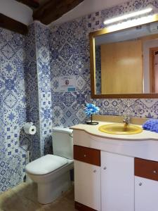 a bathroom with a toilet and a sink and a mirror at Les Mercès in Deltebre +20 photos