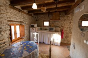 a kitchen with a counter in a stone building at Casilla Fuentes in Fuentes de Cuéllar