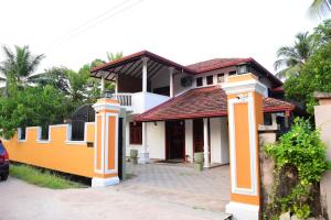 una casa de color naranja y blanco en Airport Blessings Villa, en Katunayake