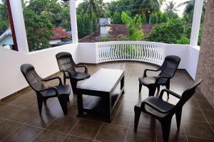 a group of chairs and a table on a patio at Airport Blessings Villa in Katunayaka