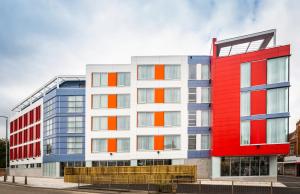 a red white and blue building on a street at Mercure Bridgwater in Bridgwater