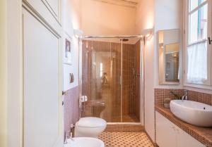 a bathroom with a shower and a toilet and a sink at Varenne Open Terrace and Private Parking in Lucca +23 photos