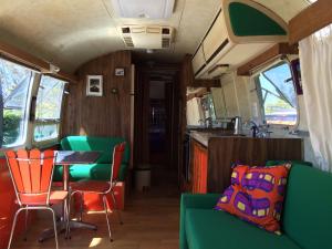 a dining room with a table and chairs in a train at Belrepayre Airstream Camp in Manses