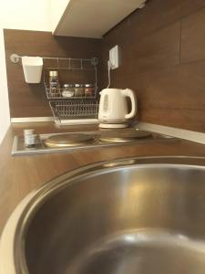 a stainless steel sink in a kitchen with a toaster at Studio apartman Rest Nest in Čakovec