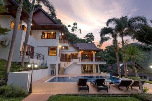 a villa with a swimming pool and a house at Patong Hill Estate 6 in Patong Beach