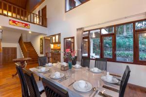 a dining room with a long table and chairs at Patong Hill Estate 6 in Patong Beach