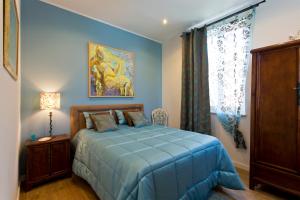 een slaapkamer met een blauw bed en een raam bij Luxurious Pink House and Parking in Porto