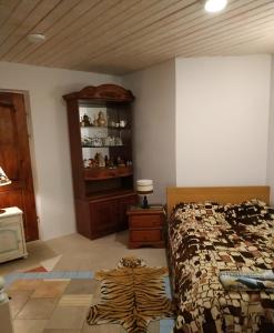 a bedroom with a bed and a cabinet and a zebra rug at Homestay Roja in Vilnius