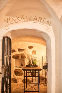 an archway with a table with wine bottles on it at Knistad Herrgård in Skövde