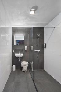 a bathroom with a shower and a sink at Logement De Oude Kazerne in Kaatsheuvel