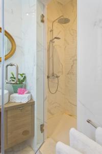 een douche met een glazen deur in een badkamer bij Luxurious Pink House and Parking in Porto