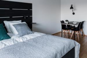 a bedroom with a bed and a table with chairs at Apartment Station in Oulu