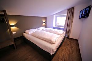 Posteľ alebo postele v izbe v ubytovaní Rider Hotel Obereggen + 22 fotografií