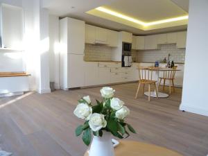 a vase with white flowers on a table in a kitchen at Bakewell Riverview in Bakewell