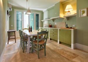 a kitchen with a table and chairs in a room at The Nest in Maremma Tuscany in Montemerano