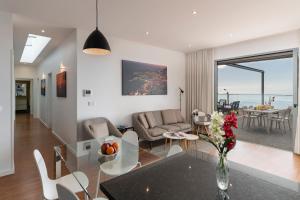 a living room with a glass table and chairs at OurMadeira - Vila da Portada, character in Funchal