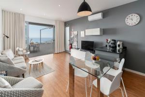 a dining room and living room with a glass table at OurMadeira - Vila da Portada, character in Funchal