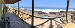a balcony of a house with a view of the ocean at Delfín Apart in Pichilemu