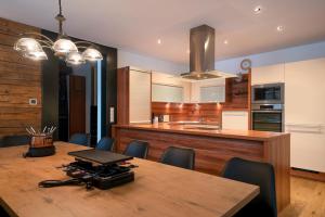 a kitchen and dining room with a table and chairs at Stadlchalet in Ried im Oberinntal