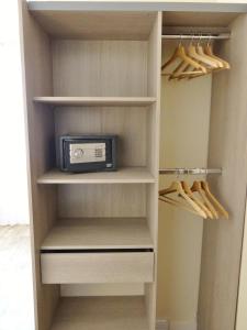 a walk in closet with a refrigerator with a microwave at Residence Hoche in Le Pré-Saint-Gervais