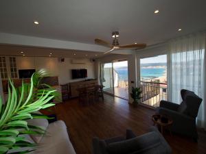 a living room with a view of the ocean at Seafront Apartment in Palamós in Palamós