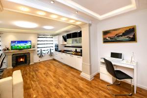 a living room with a desk and a fireplace at Apartment Markovski in Poreč