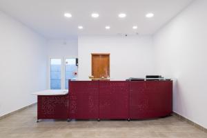 a red desk in a room with a white wall at Apartamentos Villa Canaima in Puerto del Carmen +73 photos