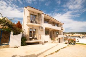 a large white building with balconies on it at Euphoria Skiathos in Skiathos