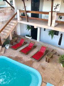 an overhead view of a swimming pool with chairs and a house at Villa Domenico in Salvador