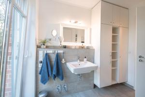 a bathroom with a sink and a mirror at Dünenstern in Wangerooge