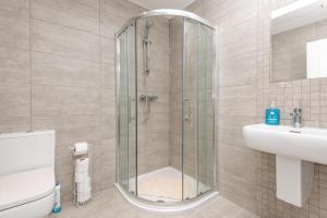 a bathroom with a shower and a toilet and a sink at The Gem in Armagh