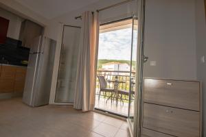 a kitchen with a sliding glass door to a balcony at Euphoria Skiathos in Skiathos