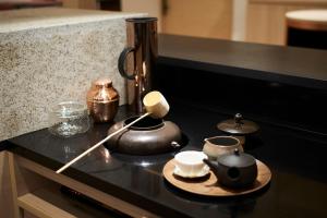a counter top with tea pots and cups on it at HOTEL 1899 TOKYO in Tokyo