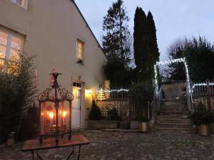 a house with a lantern in front of it with lights at La Closerie Teranga in Bayeux